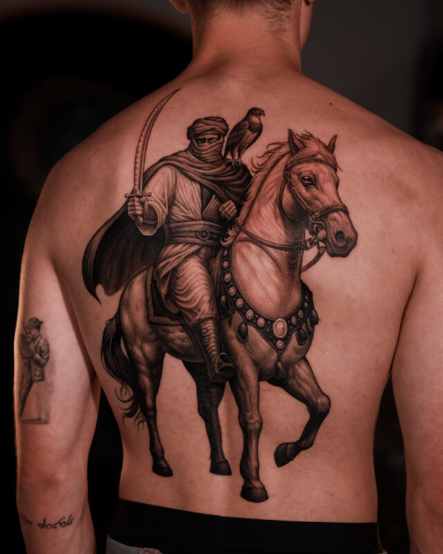 Large Blackwork warrior and horse back tattoo by Azone Tattoo Studio
