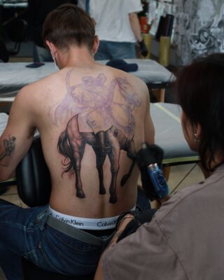 Blackwork horse rider back tattoo in progress at Azone Tattoo Studio