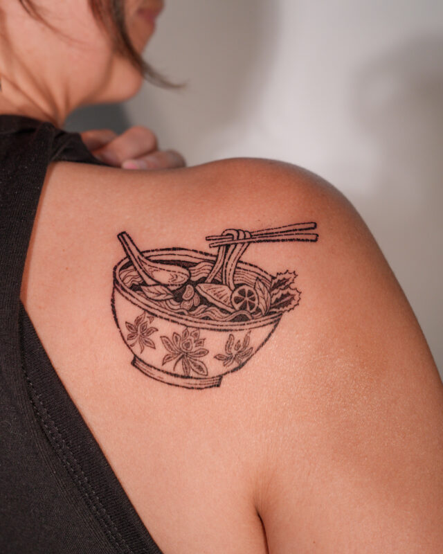 Linework Vietnamese pho bowl tattoo with chopsticks on the shoulder by Azone Tattoo Studio in saigon