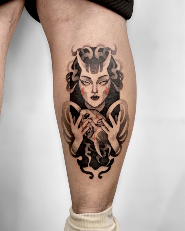 Bold blackwork leg tattoo of Japanese oni woman holding – done at Azone Tattoo Studio Hanoi
