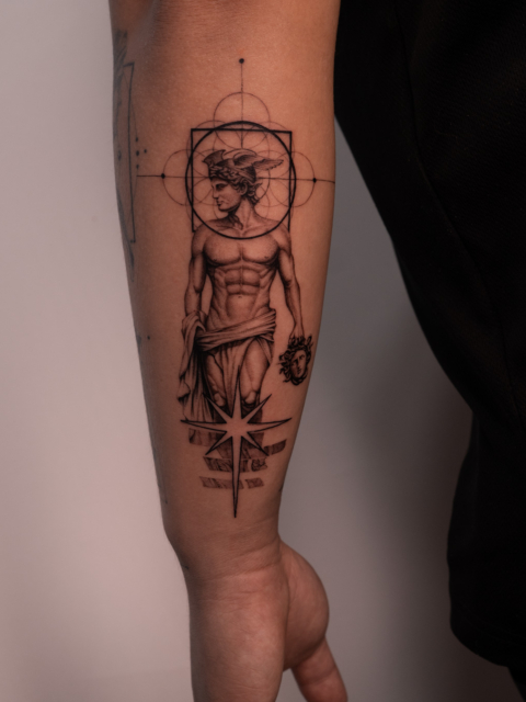 Graphic Hermes tattoo with sacred geometry and Medusa head by Azone Tattoo Studio in Hanoi and Saigon